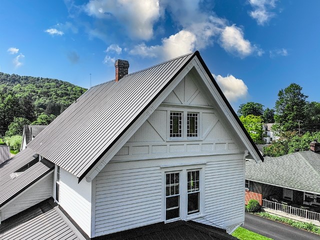306 Broad St, Port Allegany, PA 16743 - back of property with a standing seam roof, a chimney, and a metal roof