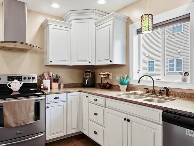 109 Alden St, Sayre, PA 18840 - kitchen featuring appliances with stainless steel finishes, wall chimney exhaust hood, a sink, white cabinetry, and decorative light fixtures