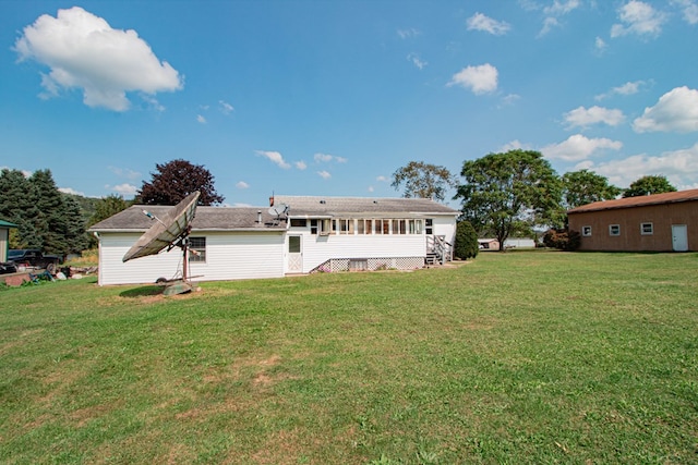 back of house with a lawn