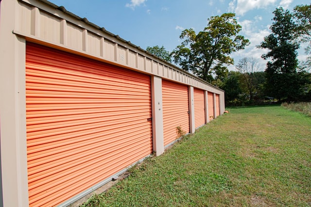 garage featuring a lawn