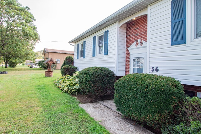 view of side of home featuring a yard