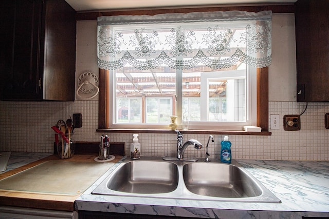 kitchen featuring decorative backsplash and sink