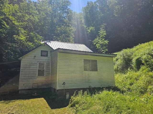225 Logue Run Rd, Austin, PA 16720 - view of side of home with a metal roof and a forest view