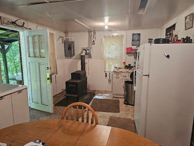 225 Logue Run Rd, Austin, PA 16720 - dining area featuring a wood stove and electric panel