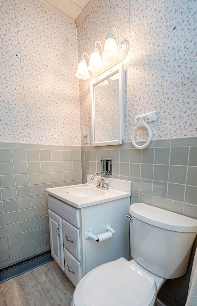 bathroom with tile walls, toilet, hardwood / wood-style floors, and vanity