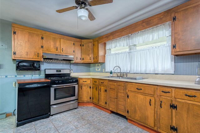 kitchen featuring sink, ceiling fan, black dishwasher, and gas range