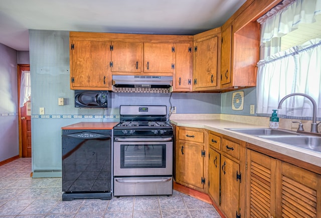 kitchen with stainless steel range with gas cooktop, black dishwasher, and sink