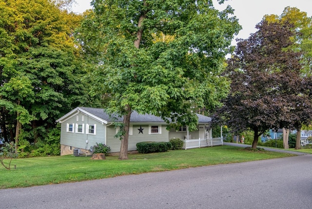 view of front of property with cooling unit and a front lawn