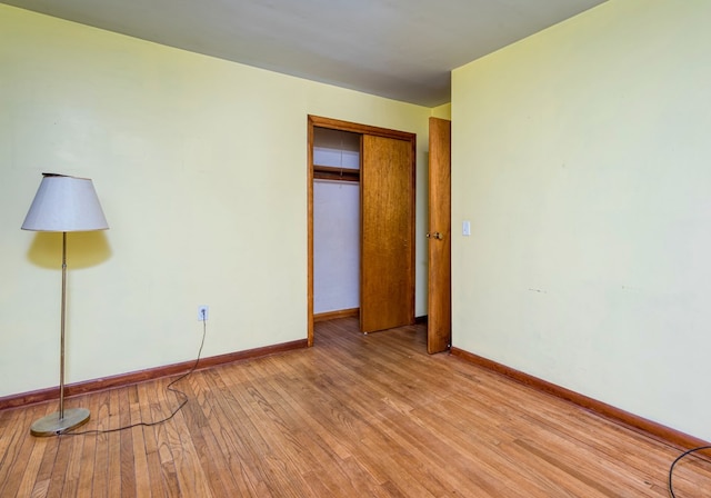 unfurnished bedroom featuring a closet and light hardwood / wood-style flooring