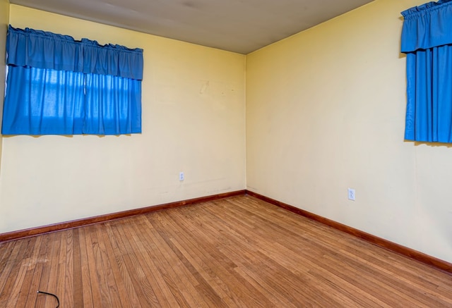 empty room with hardwood / wood-style floors