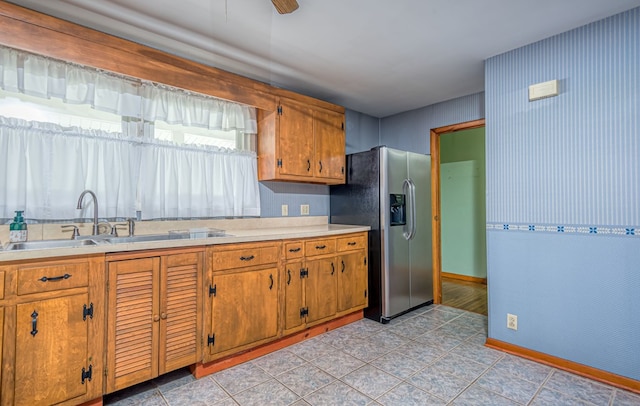 kitchen with ceiling fan, stainless steel fridge with ice dispenser, and sink