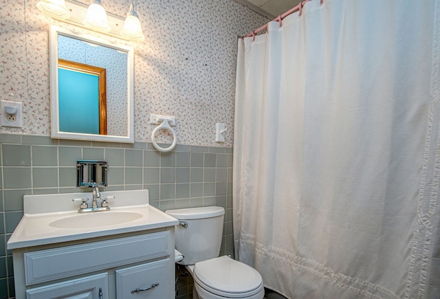 bathroom with toilet, vanity, tile walls, and a shower with curtain