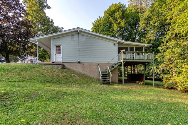 back of house with a deck and a yard