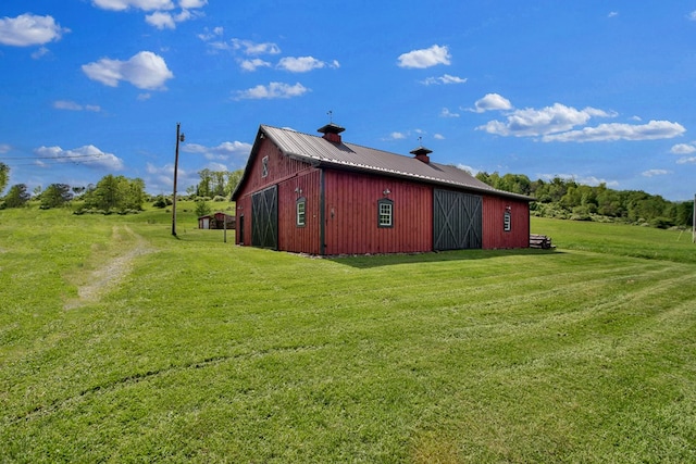1349 Hills Creek Rd, Wellsboro, PA 16901 - view of side of home featuring a lawn, a chimney, an outdoor structure, and metal roof