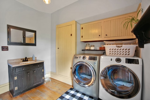 1349 Hills Creek Rd, Wellsboro, PA 16901 - laundry room with cabinet space, washing machine and clothes dryer, light wood-style flooring, and baseboards