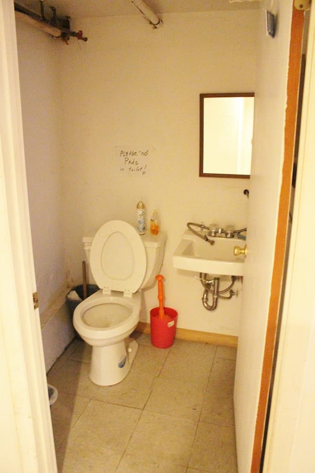 bathroom with tile patterned floors, toilet, and sink