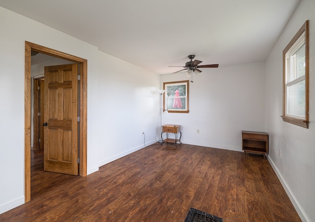 empty room featuring ceiling fan and dark wood-type flooring