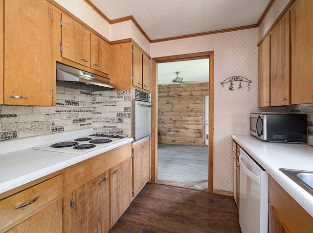 kitchen featuring sink, stainless steel appliances, dark hardwood / wood-style floors, backsplash, and ornamental molding