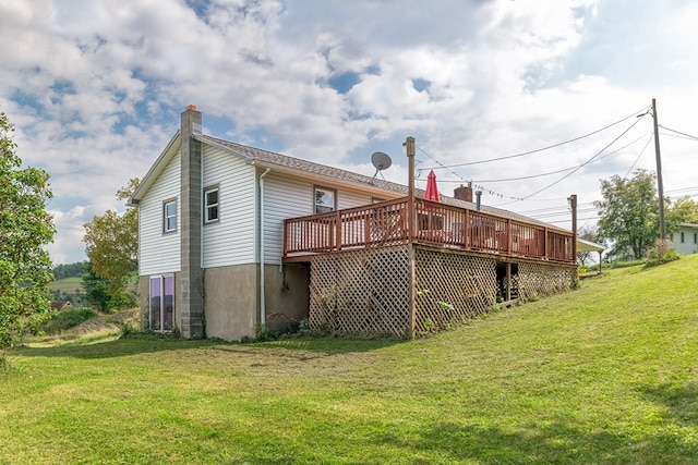 rear view of property with a lawn and a deck