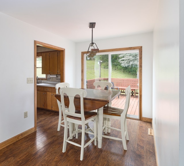 dining room with dark hardwood / wood-style flooring