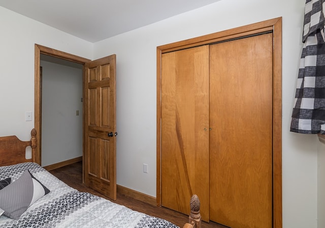 bedroom with a closet and dark wood-type flooring