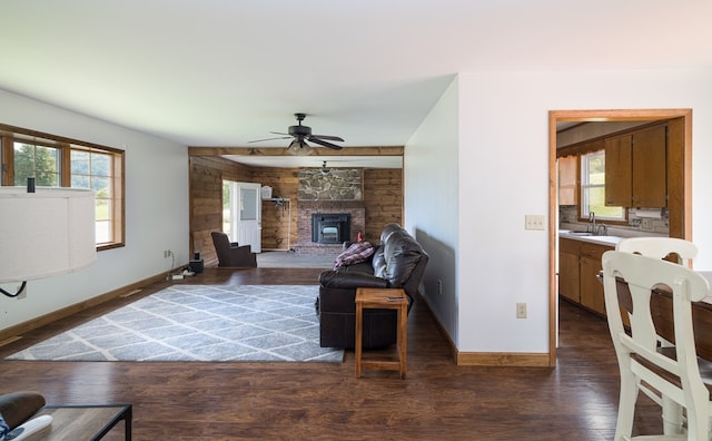 living room with ceiling fan, a healthy amount of sunlight, sink, and dark wood-type flooring