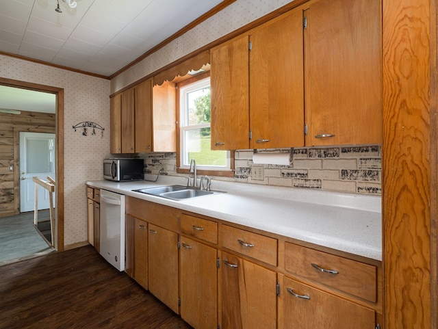 kitchen with dishwasher, sink, tasteful backsplash, dark hardwood / wood-style floors, and ornamental molding