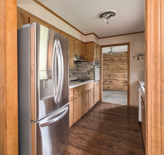 kitchen with crown molding, dark hardwood / wood-style floors, ceiling fan, tasteful backsplash, and stainless steel appliances