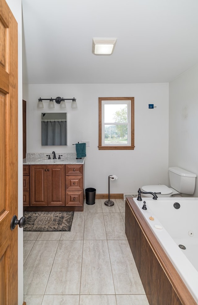 bathroom featuring a tub to relax in, tile patterned floors, vanity, and toilet