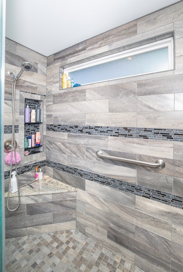 bathroom with a tile shower