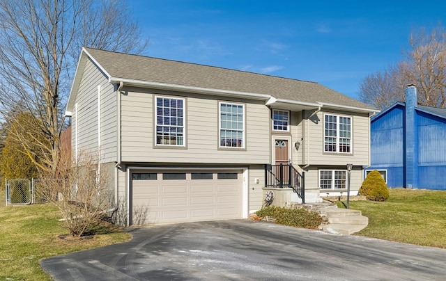 split foyer home featuring a front yard and a garage