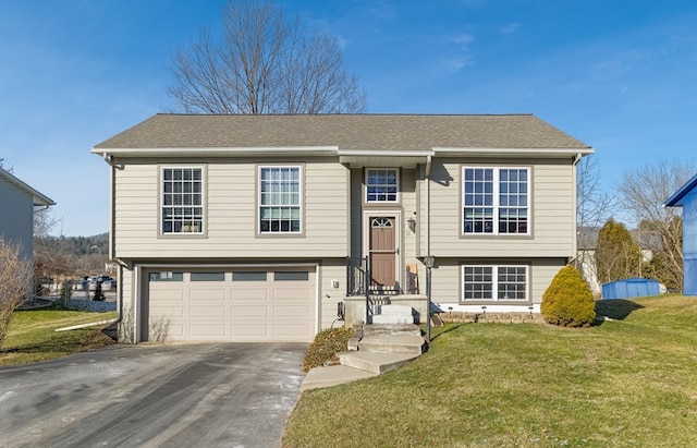 split foyer home with a front yard and a garage