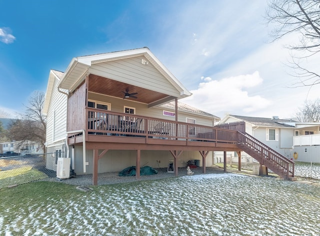 snow covered rear of property featuring a wooden deck and ceiling fan