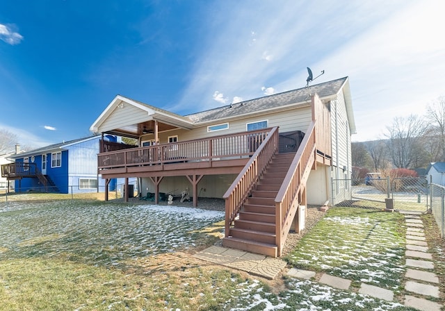 rear view of property with a lawn, a deck, and ceiling fan