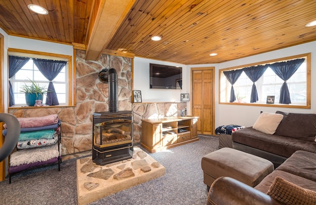 carpeted living room with wooden ceiling, a wood stove, and beam ceiling