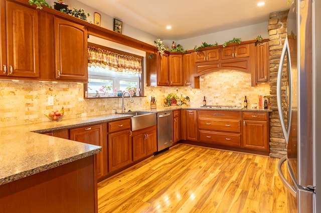 5 Eberenz St, Wellsboro, PA 16901 - kitchen with light wood-type flooring, a sink, light stone counters, appliances with stainless steel finishes, and brown cabinets