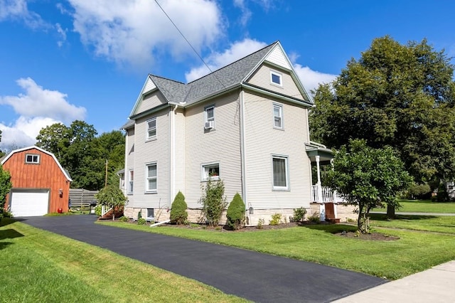 5 Eberenz St, Wellsboro, PA 16901 - view of side of home featuring a lawn, a detached garage, an outdoor structure, and roof with shingles