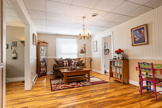 5 Eberenz St, Wellsboro, PA 16901 - living room featuring light wood finished floors, a baseboard radiator, visible vents, and a paneled ceiling