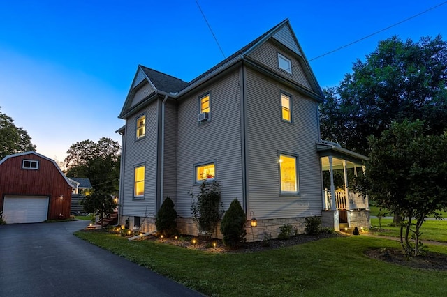 5 Eberenz St, Wellsboro, PA 16901 - view of side of home with aphalt driveway, a detached garage, an outdoor structure, and a yard