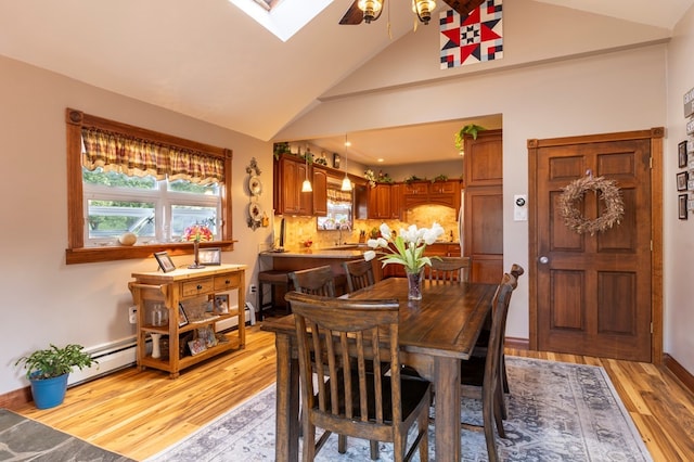 5 Eberenz St, Wellsboro, PA 16901 - dining area featuring high vaulted ceiling, a skylight, a ceiling fan, a baseboard heating unit, and light wood-type flooring