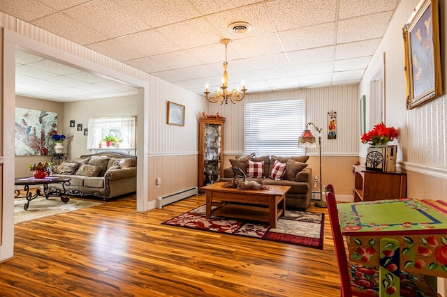 5 Eberenz St, Wellsboro, PA 16901 - living area featuring visible vents, wood finished floors, baseboard heating, and a chandelier
