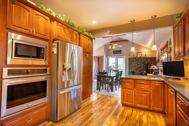 5 Eberenz St, Wellsboro, PA 16901 - kitchen with vaulted ceiling, appliances with stainless steel finishes, a peninsula, light wood-type flooring, and ceiling fan