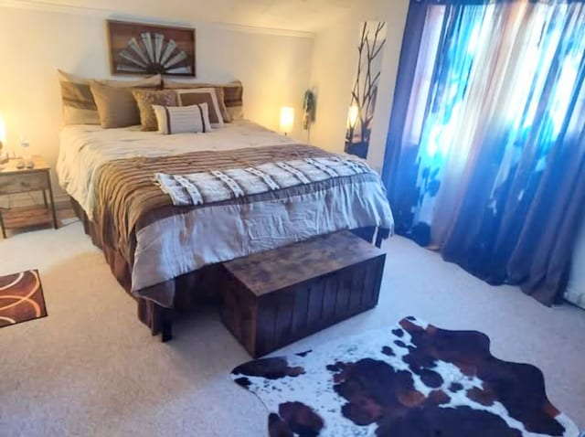 carpeted bedroom with ornamental molding