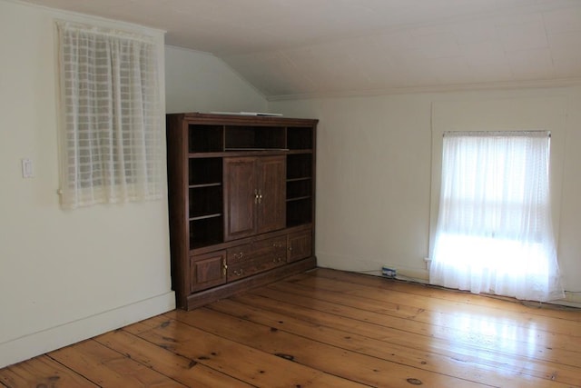 empty room featuring lofted ceiling and hardwood / wood-style flooring