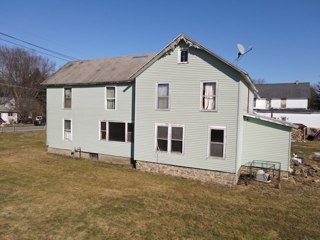 rear view of house with a yard