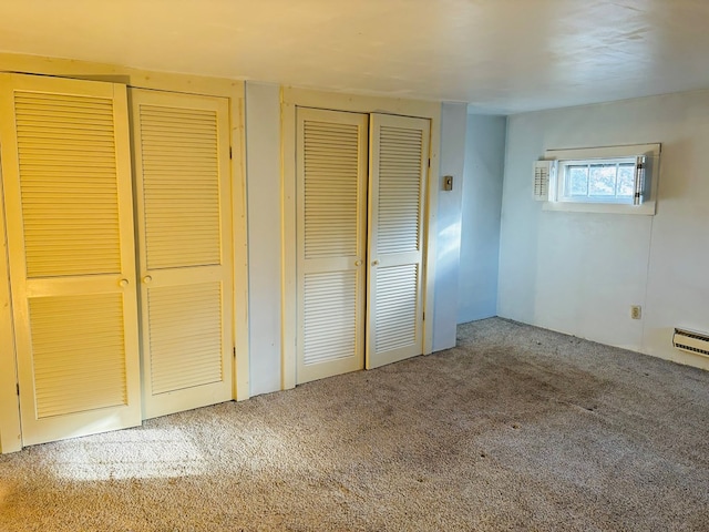 unfurnished bedroom featuring multiple closets and carpet floors