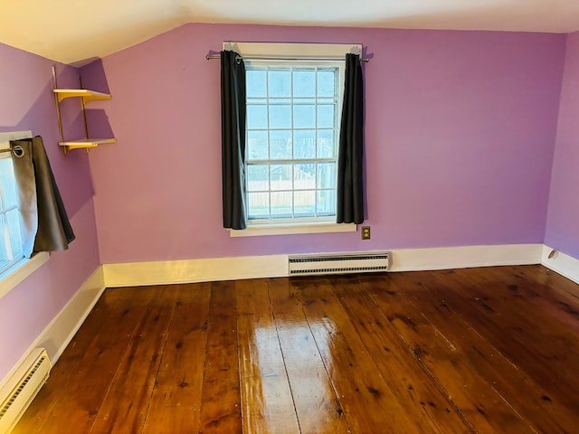 spare room with a baseboard radiator, lofted ceiling, and hardwood / wood-style floors