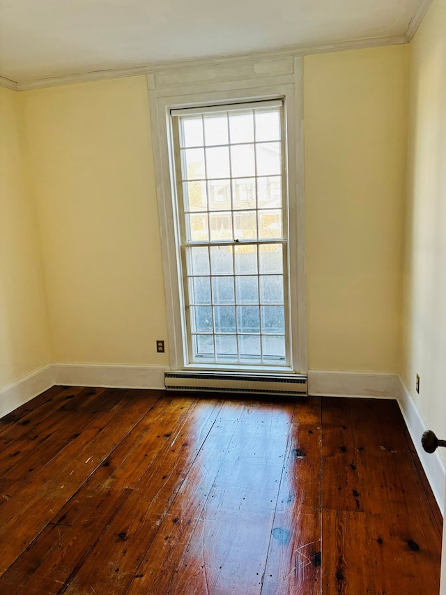 unfurnished room featuring a wealth of natural light, dark hardwood / wood-style flooring, and baseboard heating