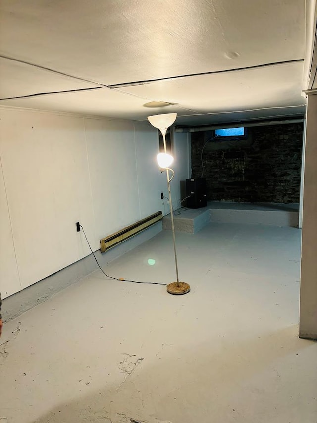 basement featuring a baseboard heating unit