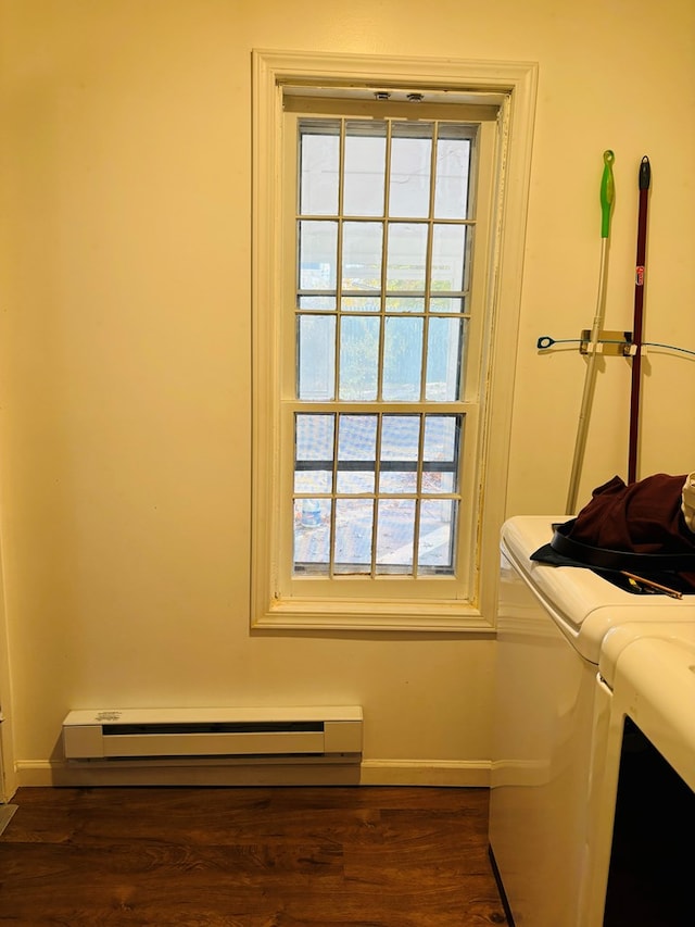 laundry room with baseboard heating, separate washer and dryer, and dark hardwood / wood-style floors